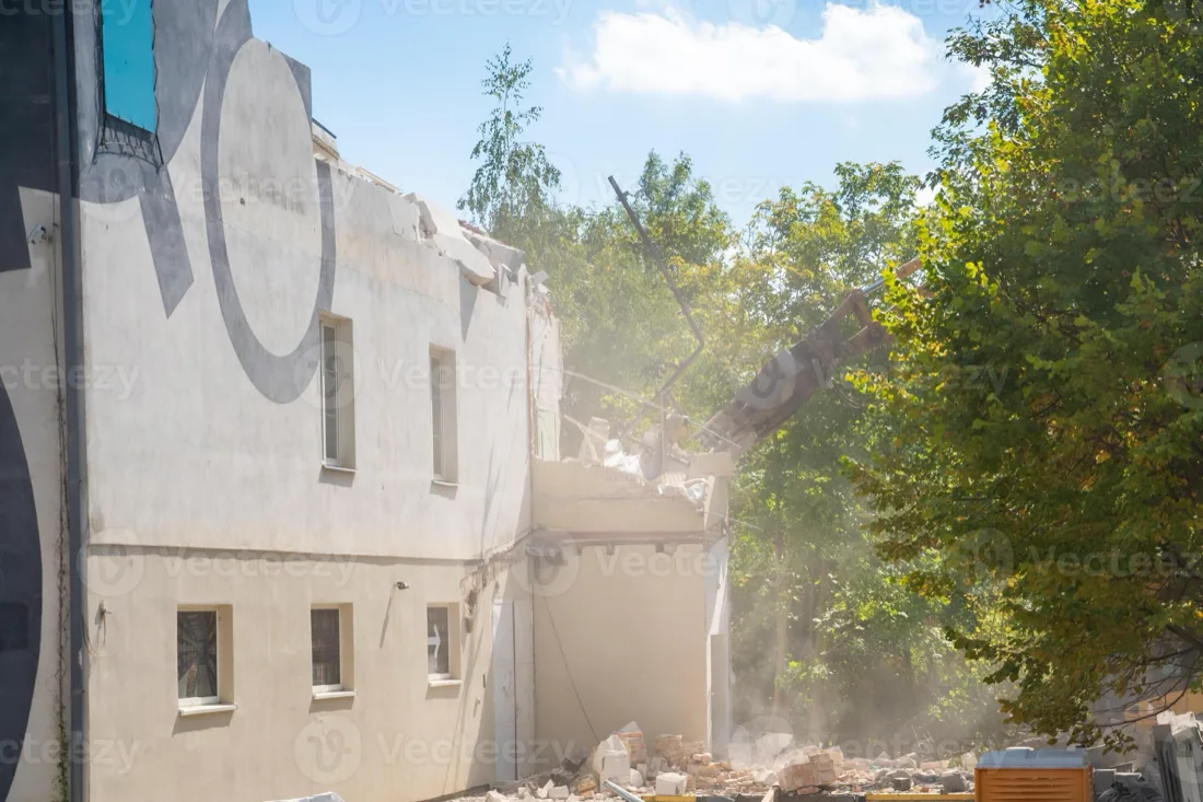 Excavator tearing down an old structure during demolition near Bay Minette, AL